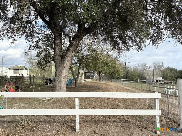 a view of backyard with large trees