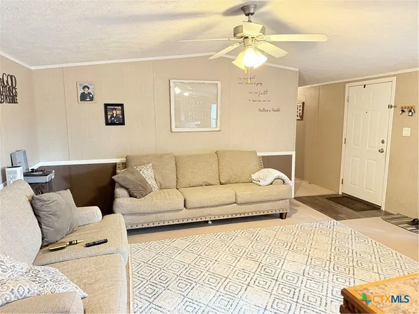 a living room with furniture and a white walls
