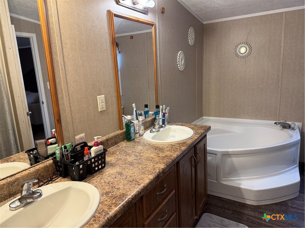 107 Dallas Street Goliad, TX 77963 - Photo 5 of 28 a bathroom with a granite countertop sink and a mirror