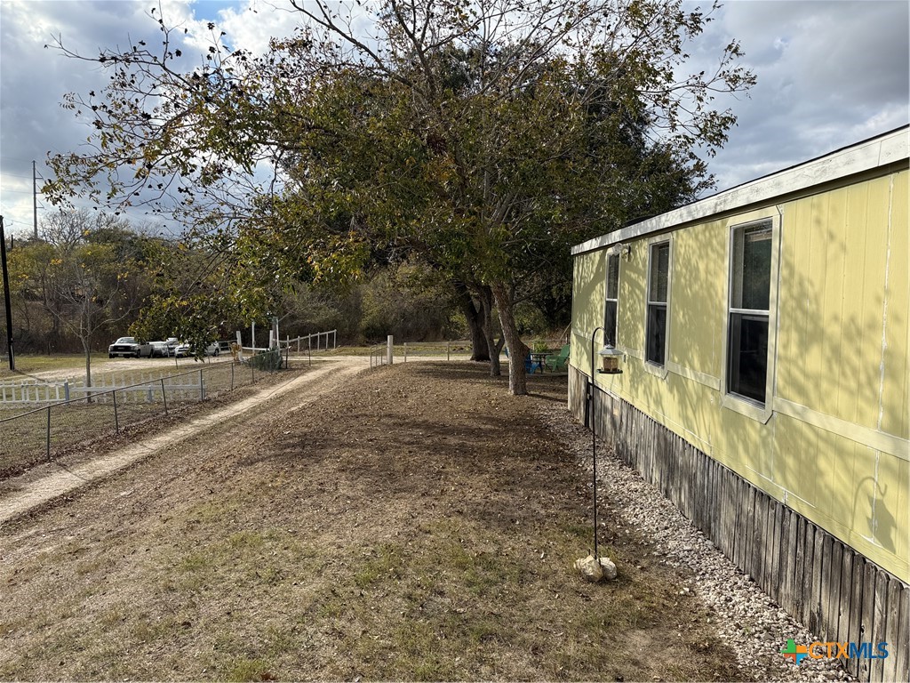 107 Dallas Street Goliad, TX 77963 - Photo 6 of 28 a view of a pathway with a wrought fence