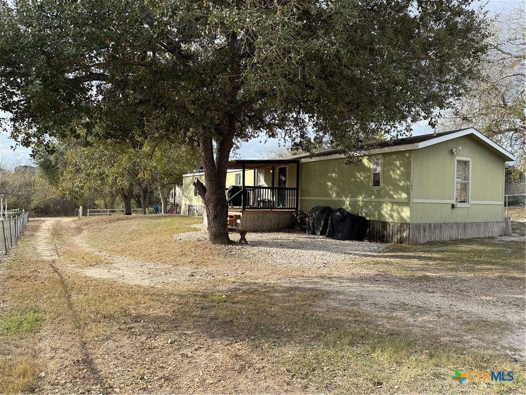 107 Dallas Street Goliad, TX 77963 - Photo 7 of 28 a front view of a house with a yard and garage