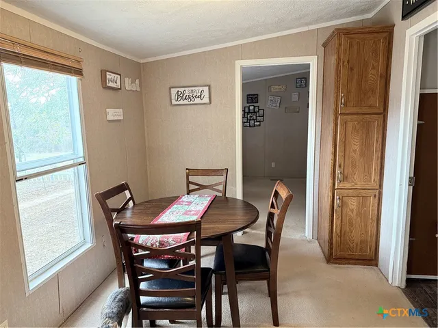 a view of a dining room with furniture and window