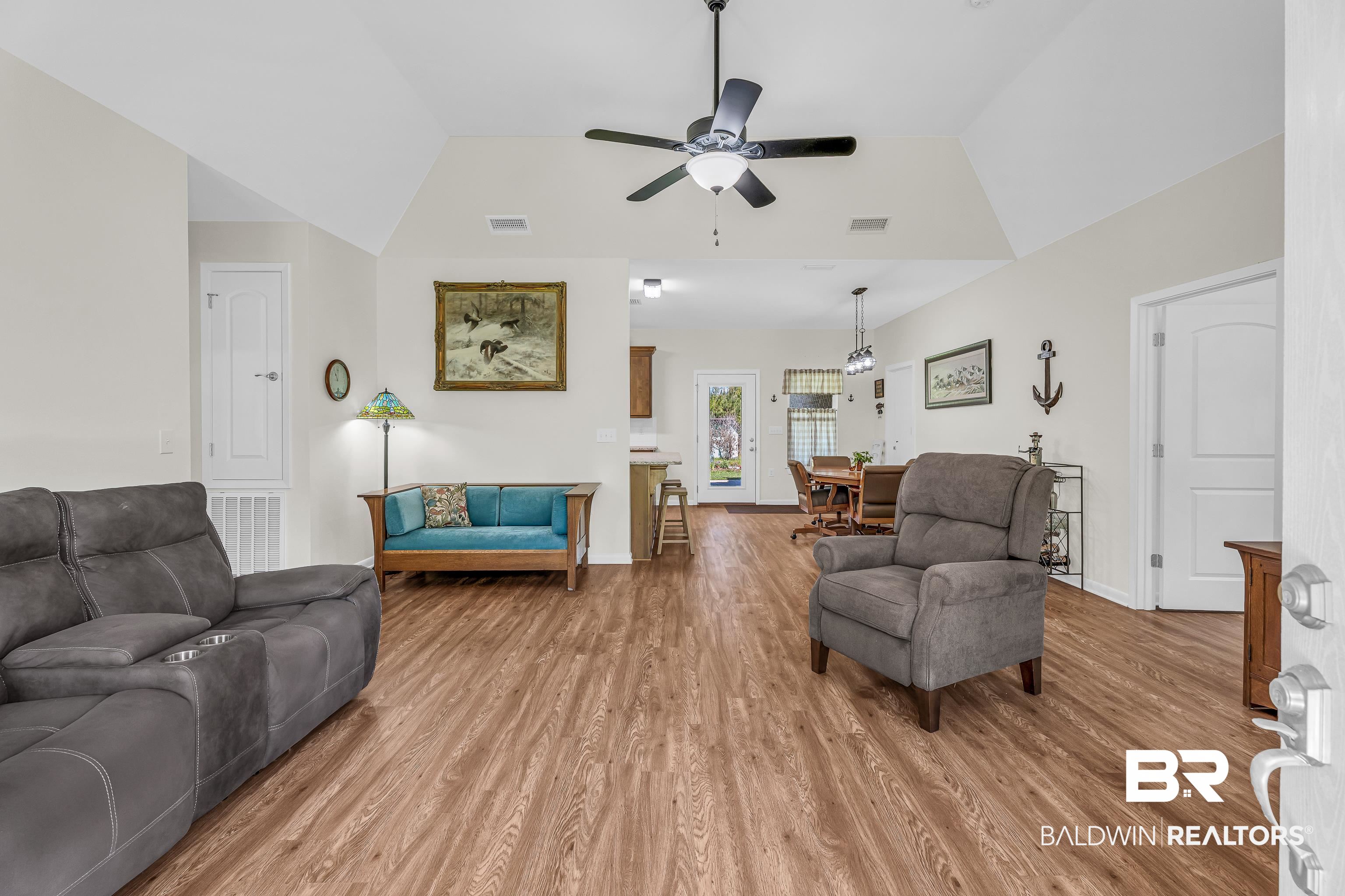 18255 Cactus Court Elberta, AL 36530 - Photo 10 of 53 Living area featuring a ceiling fan, vaulted ceiling, and light wood-style flooring