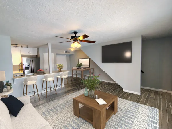 a living room with furniture and a wooden floor