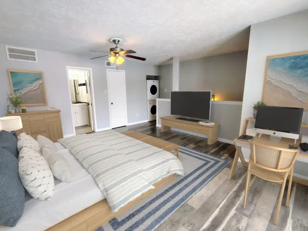 a bedroom with a bed and wooden floor