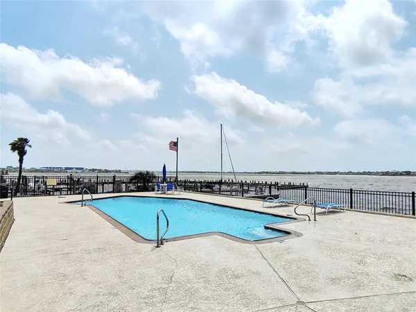 a view of swimming pool with outdoor seating
