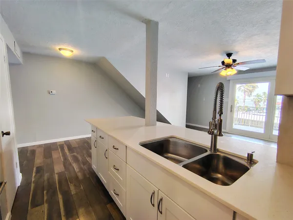 a kitchen with a sink and chandelier