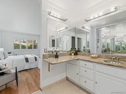 a spacious bathroom with a granite countertop sink mirror and