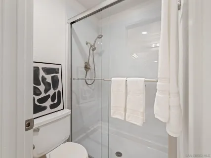 a bathroom with a shower and toilet