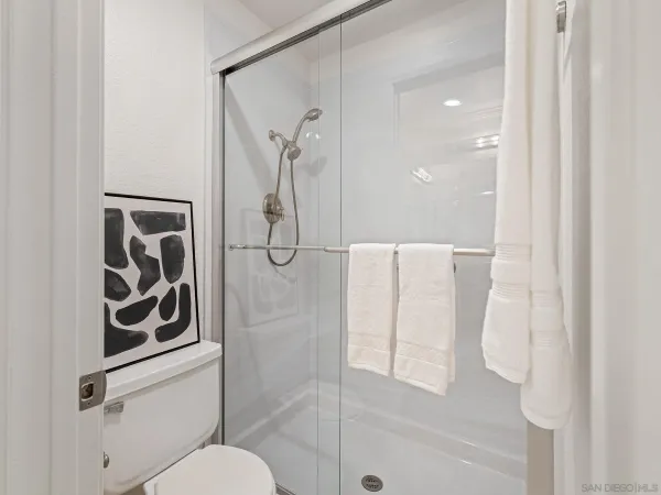 a bathroom with a shower and toilet