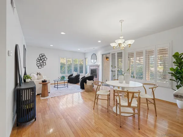 a living room with furniture a chandelier and a wooden floor