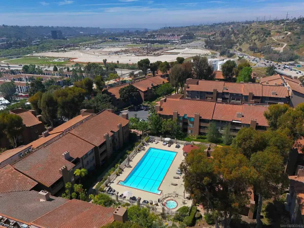 an aerial view of residential houses with outdoor space and river