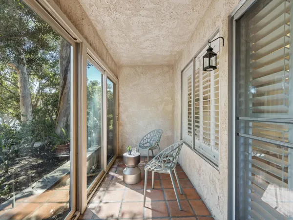 a balcony with furniture and wooden floor