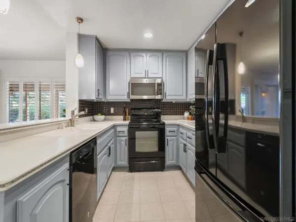 a kitchen with a sink stove and refrigerator