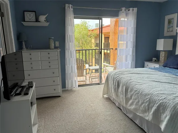 a spacious bedroom with a bed and with furniture