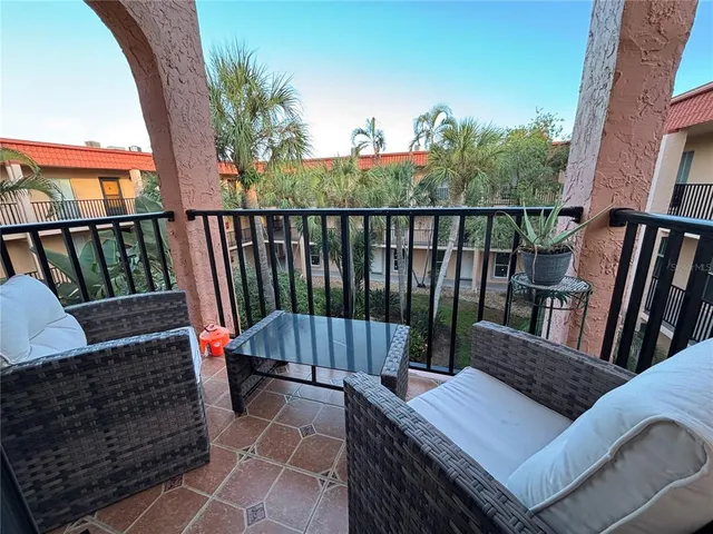 a view of balcony with wooden floor and outdoor seating