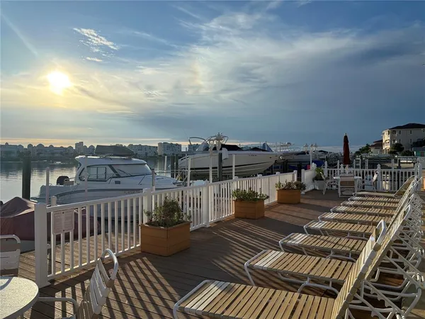 a view of a roof deck with two couches and wooden floor