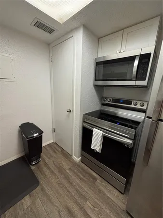 a living room with a stove and a bookshelf