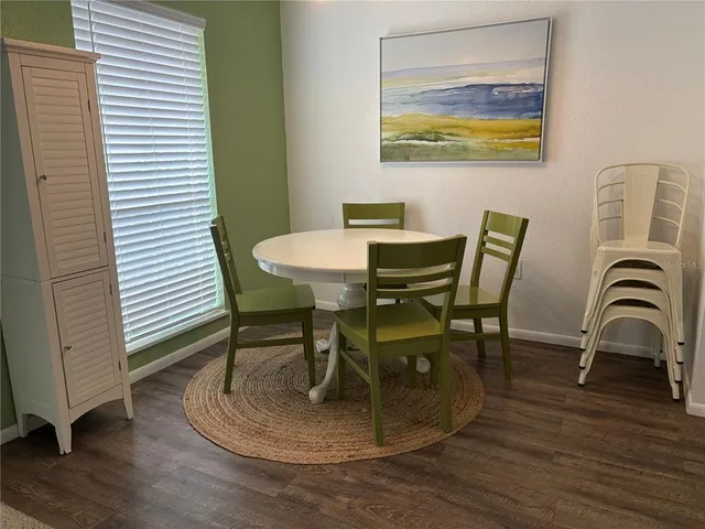 a dining room with furniture and wooden floor