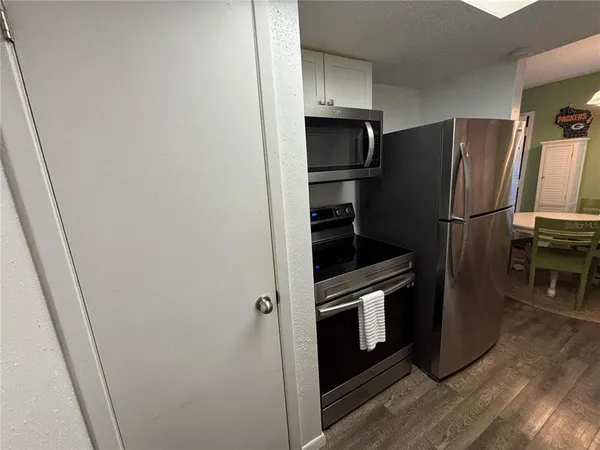 a metallic refrigerator freezer sitting in a kitchen