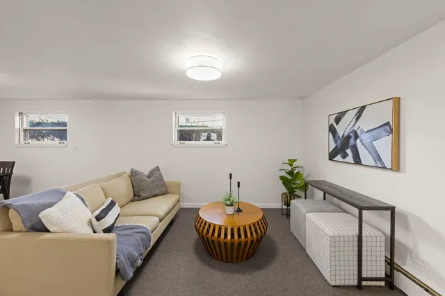 a living room with furniture and a potted plant