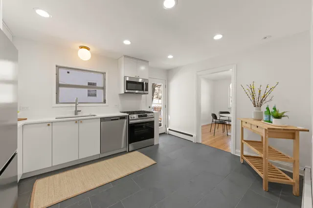 a large white kitchen with cabinets
