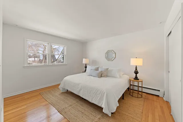 a bedroom with a bed and a night stand