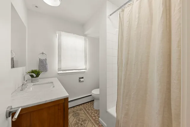 a bath room with a sink and a bath tub