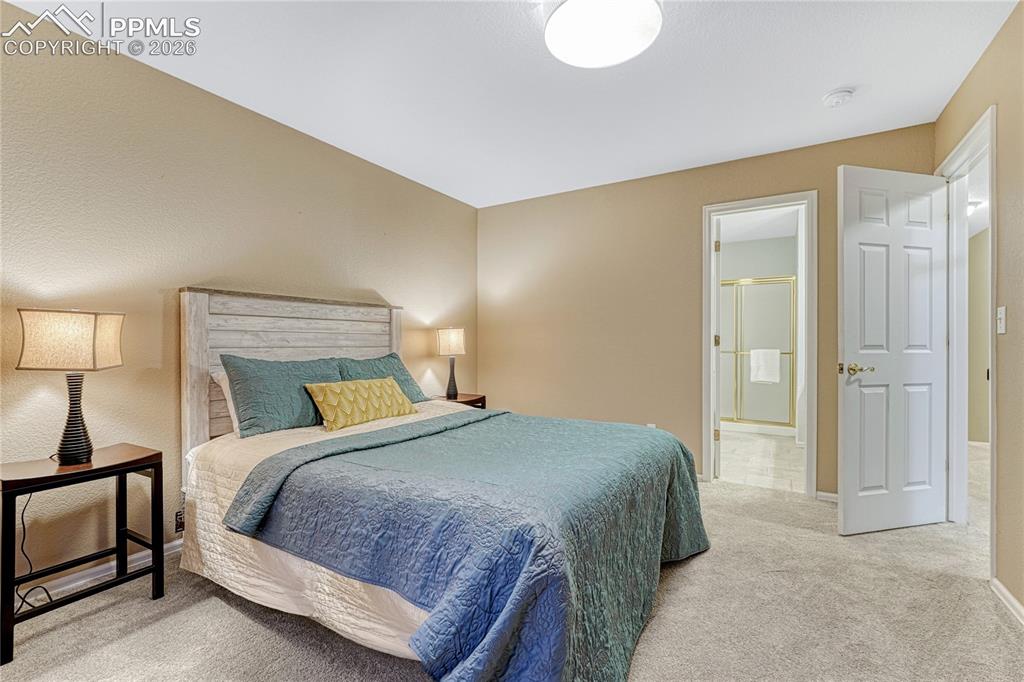 15585 Falcon Ridge Court Colorado Springs, CO 80921 - Photo 27 of 50 a bedroom with a bed and lamp