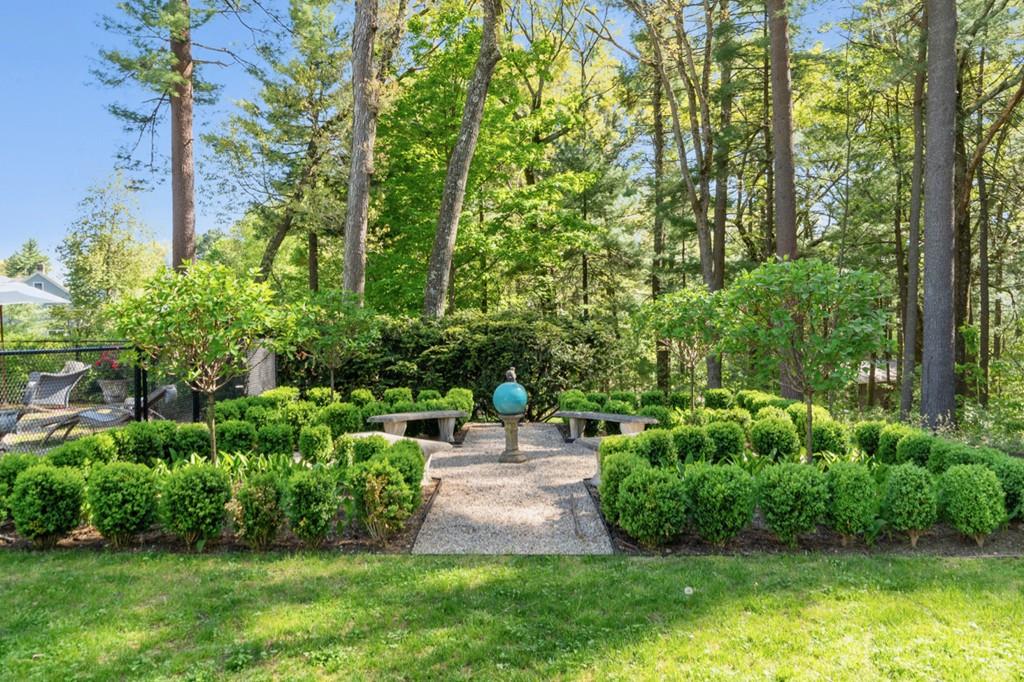 107 Independence Road Concord, MA 01742 - Photo 20 of 25 a view of a patio with table and chairs plants and large trees
