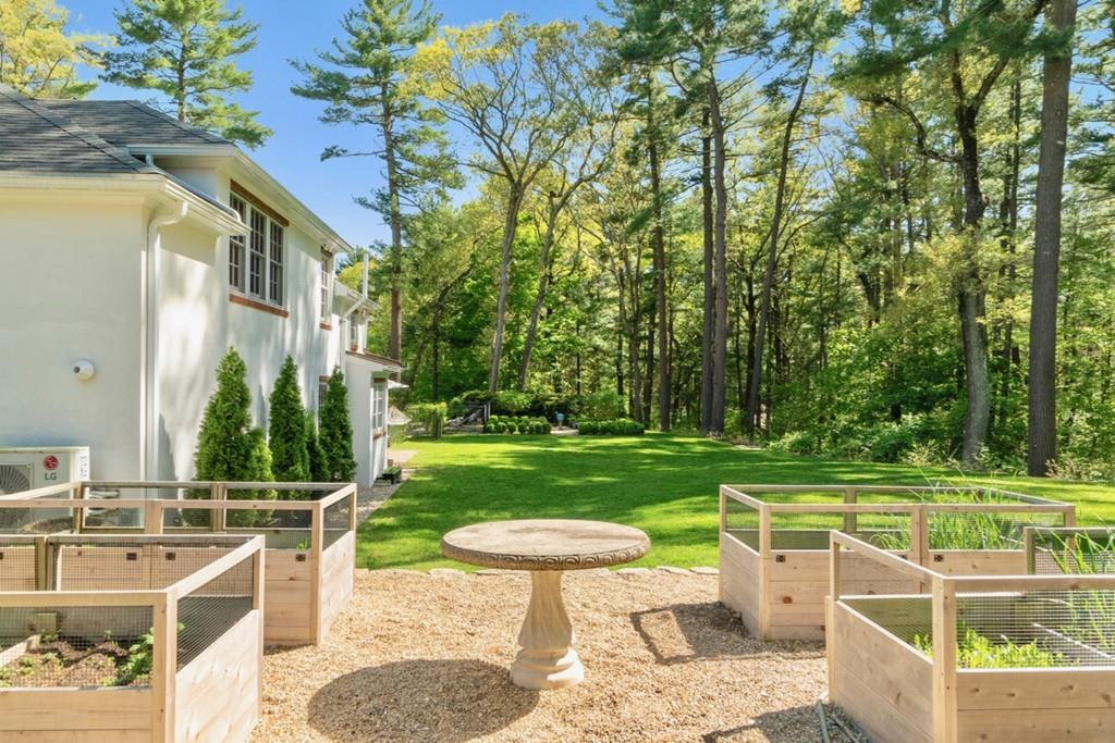 107 Independence Road Concord, MA 01742 - Photo 22 of 25 a view of a patio with a table chairs and a fire pit