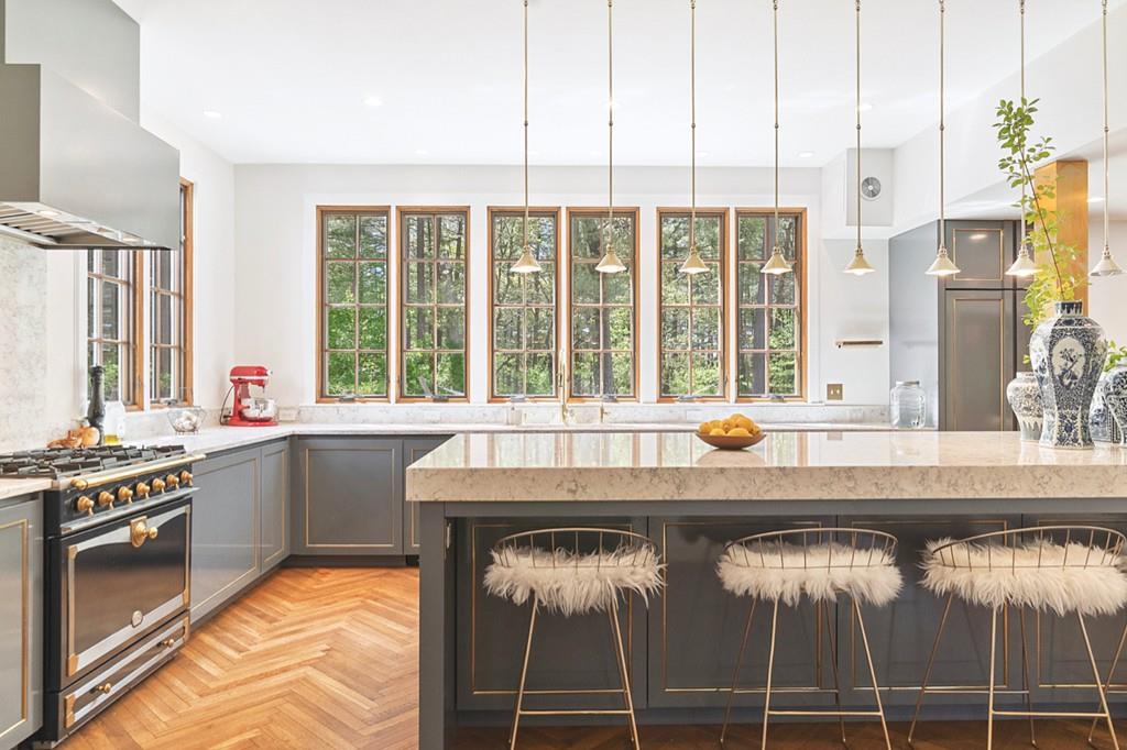 107 Independence Road Concord, MA 01742 - Photo 5 of 25 a kitchen with a stove a sink and a wooden floor