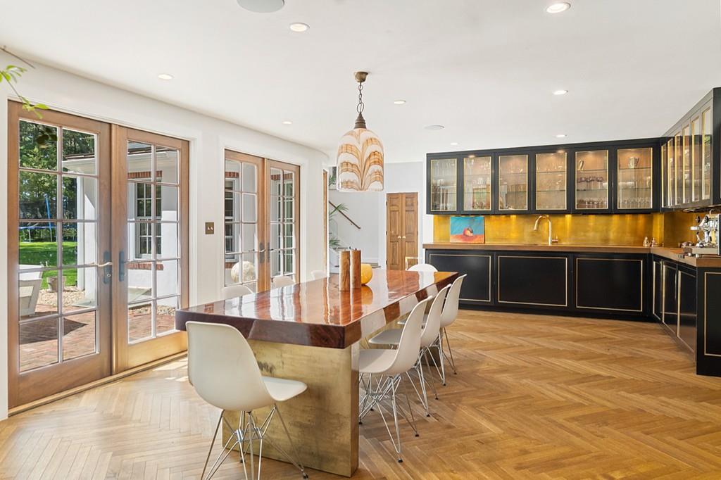 107 Independence Road Concord, MA 01742 - Photo 6 of 25 a dining room with wooden floor and large windows