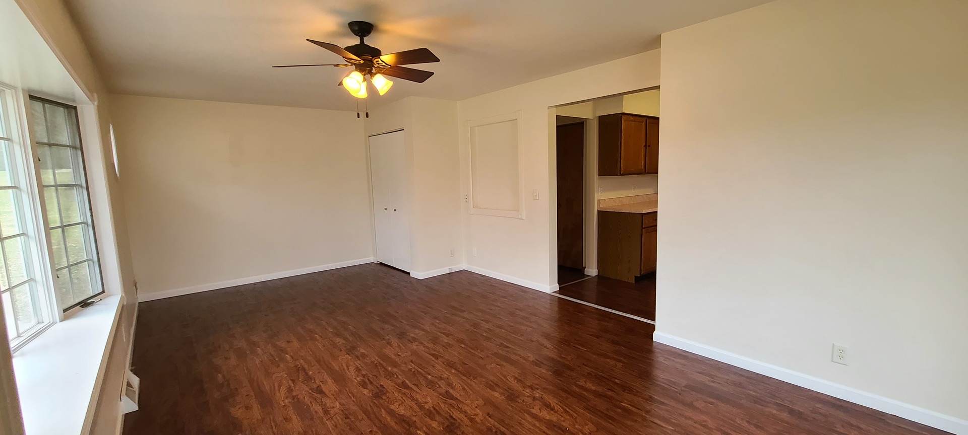 2225 Daysville Road Oregon, IL 61061 - Photo 3 of 28 a big room with wooden floor a chandelier fan and windows