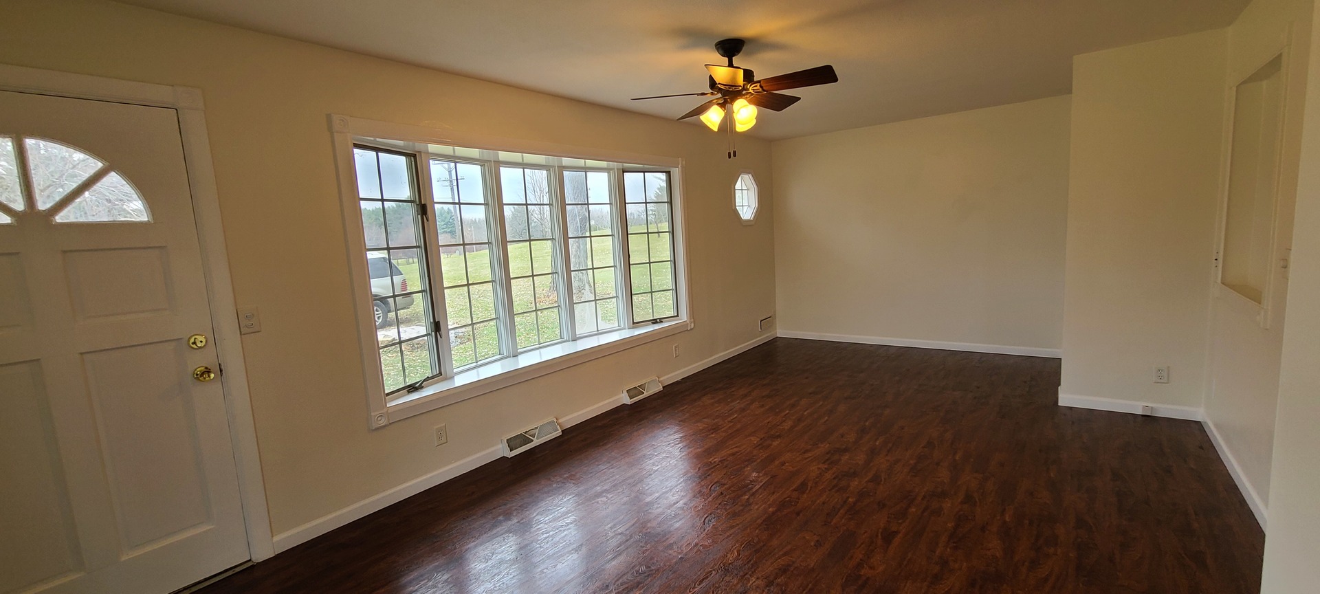 2225 Daysville Road Oregon, IL 61061 - Photo 5 of 28 a view of an empty room with a window and wooden floor