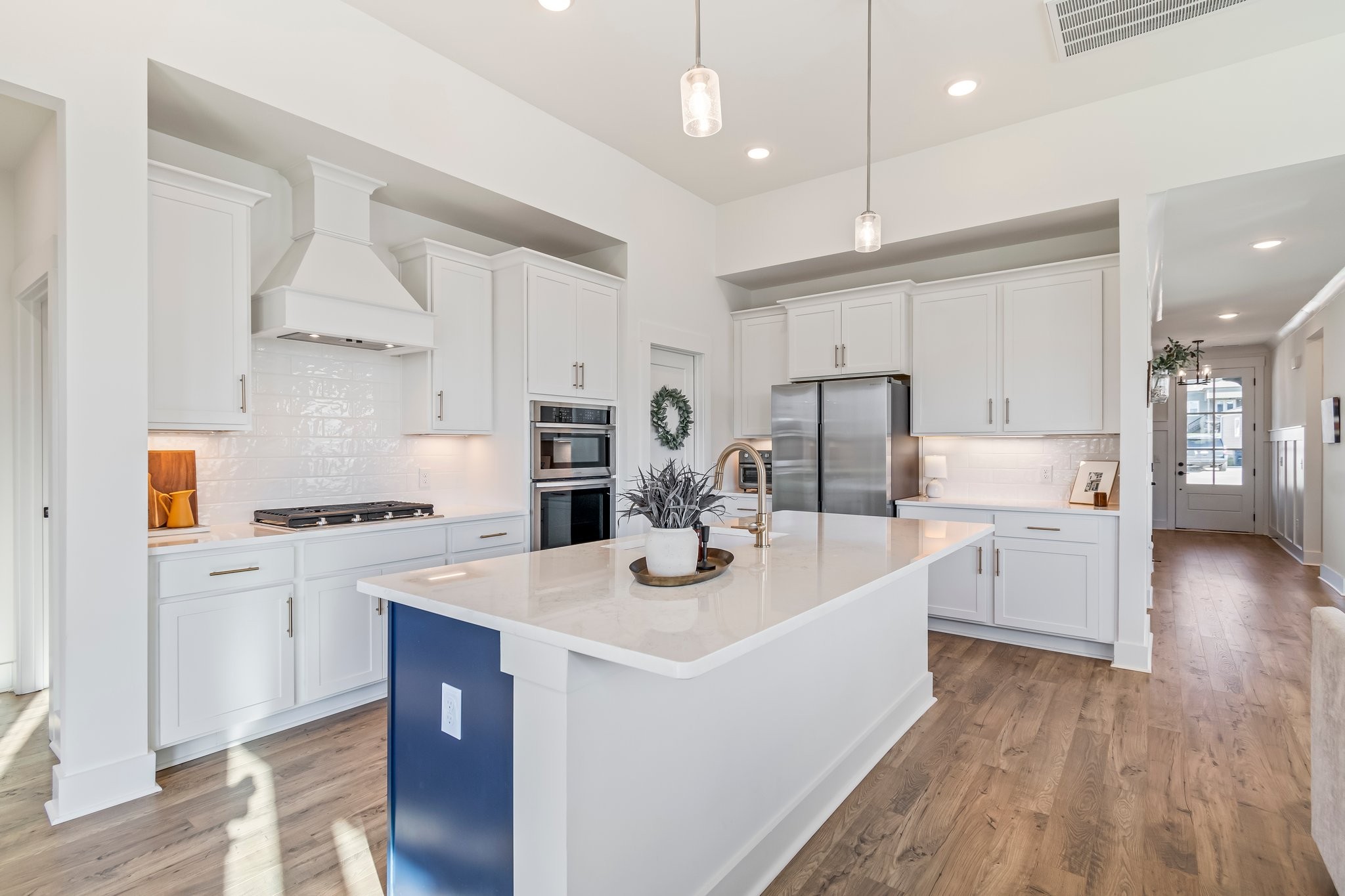 4028 John Marsh Road Spring Hill, TN 37174 - Photo 21 of 62 a kitchen that has a lot of white cabinets and stainless steel appliances