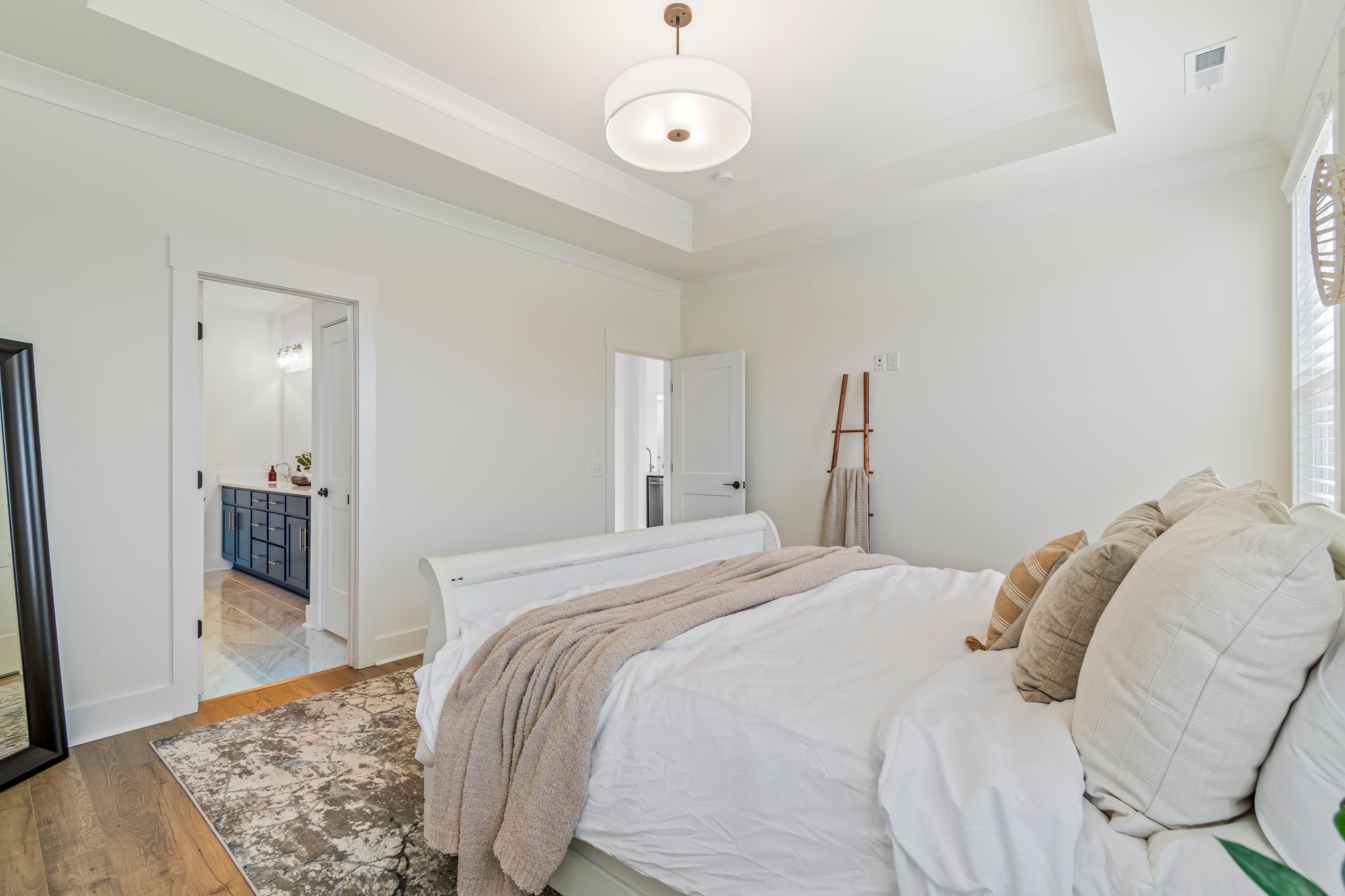 4028 John Marsh Road Spring Hill, TN 37174 - Photo 29 of 62 a bedroom with a bed and a table with wooden floor