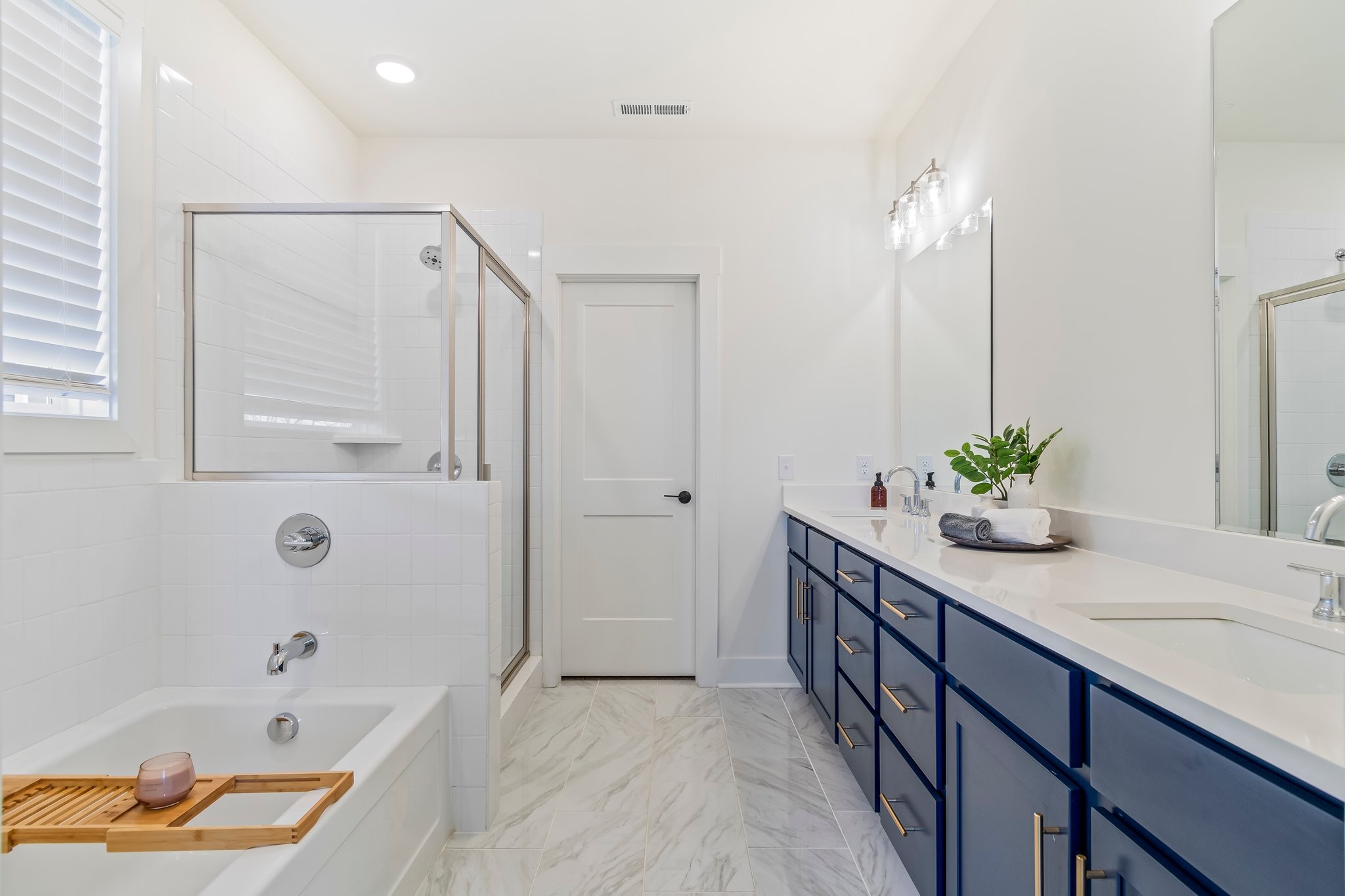 4028 John Marsh Road Spring Hill, TN 37174 - Photo 30 of 62 a bathroom with a tub sink and mirror
