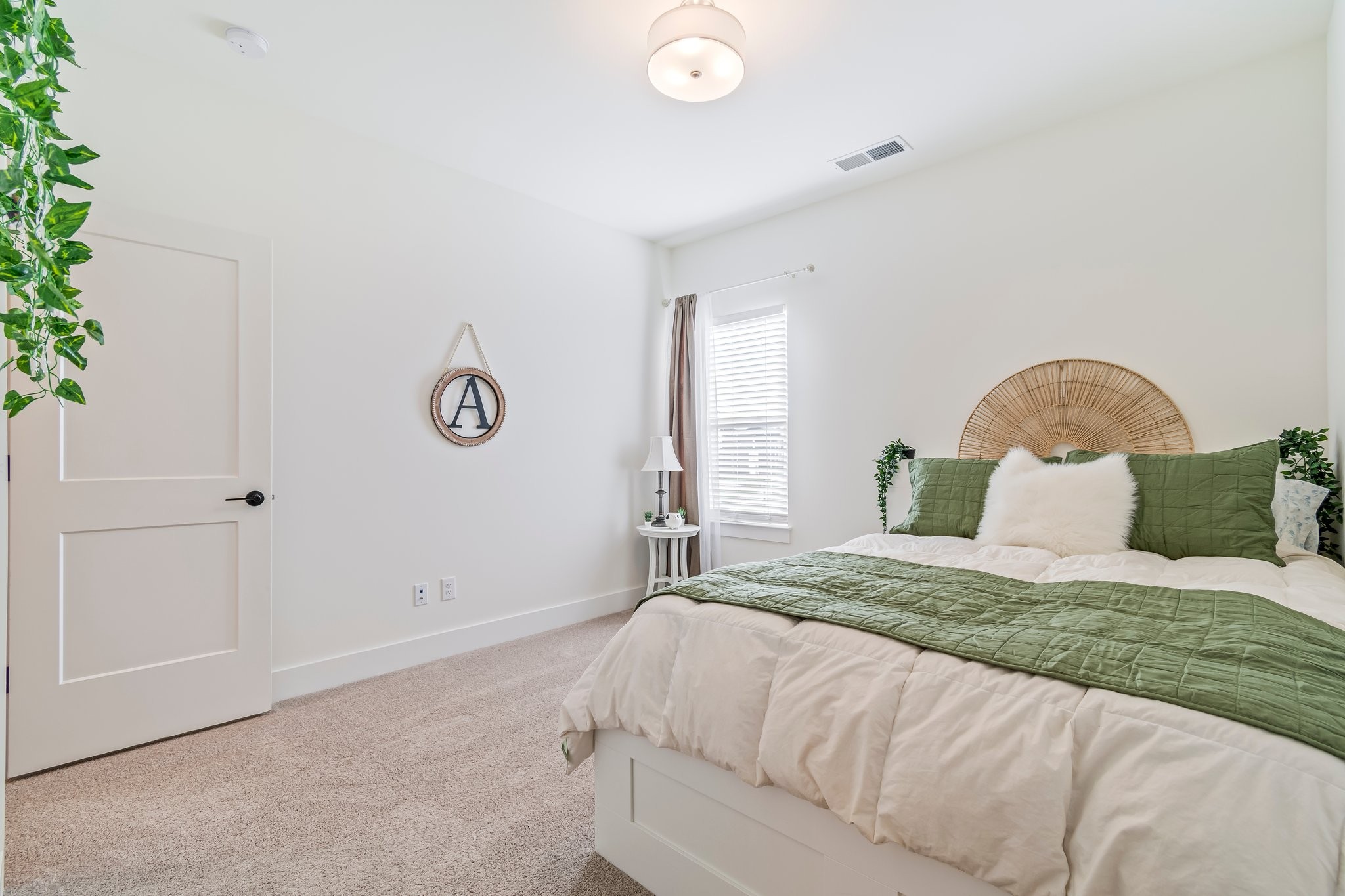 4028 John Marsh Road Spring Hill, TN 37174 - Photo 42 of 62 a bedroom with a bed and a potted plant