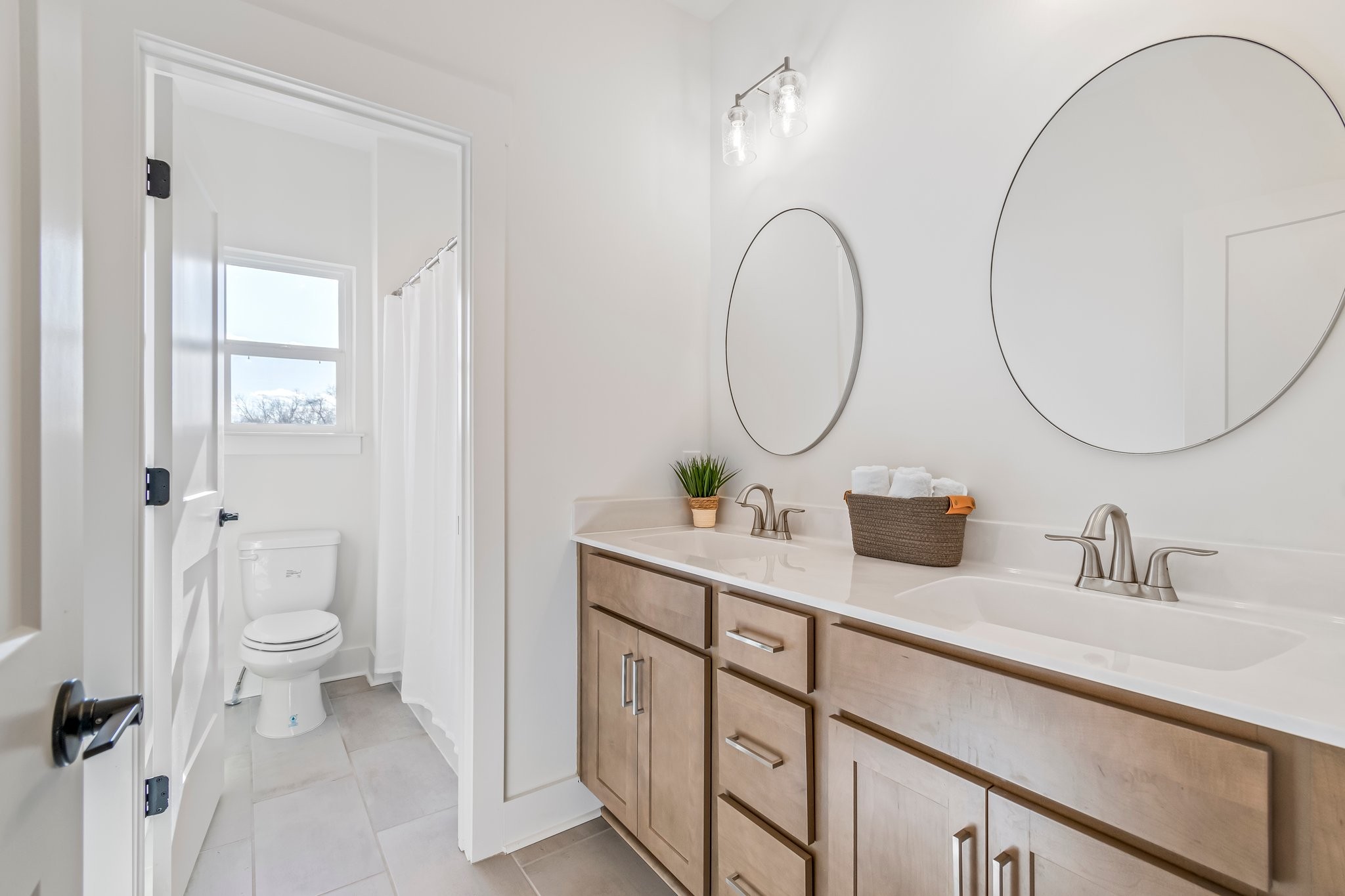4028 John Marsh Road Spring Hill, TN 37174 - Photo 47 of 62 a bathroom with a toilet a sink a mirror and a shower