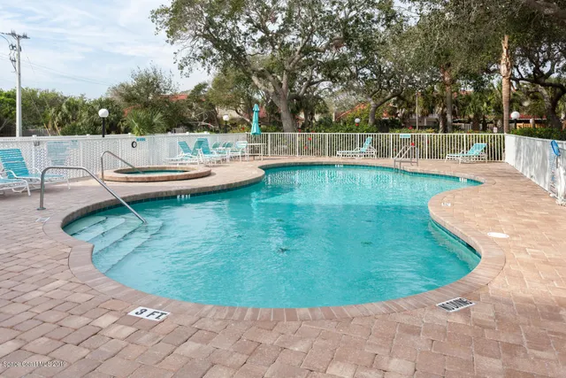a view of a swimming pool with a patio
