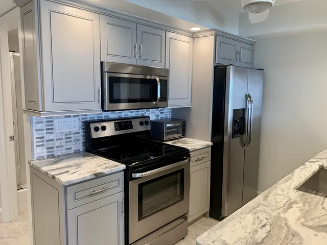 a kitchen with a stove microwave and refrigerator