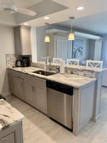 a kitchen with a sink stove and cabinets