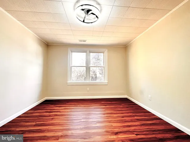 an empty room with gym equipment and a large window