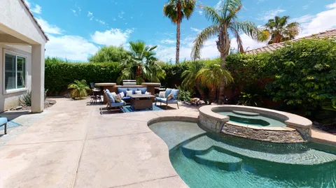 a view of swimming pool with outdoor seating and plants