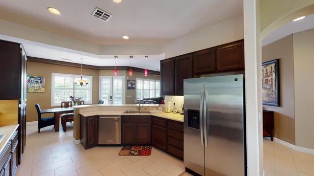 a kitchen with refrigerator and furniture
