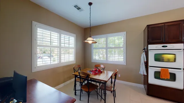 a dining room with furniture and window