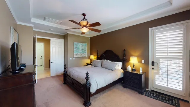 a bedroom with a bed a window and a flat screen television