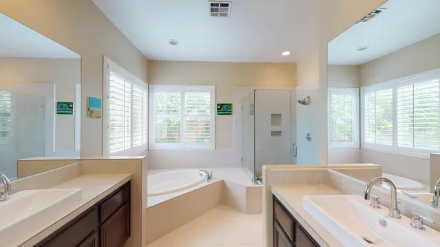 a bathroom with a tub sink and mirror