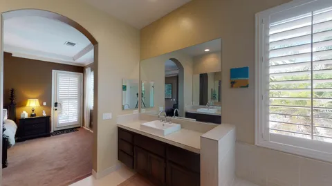 a bathroom with a double vanity sink and a mirror